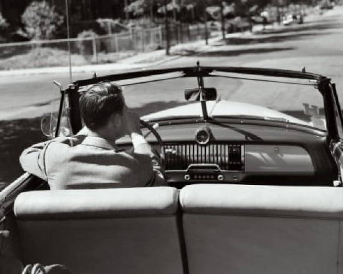 Rear view of a young man driving a convertible car Canvas Art - (24 x 36)