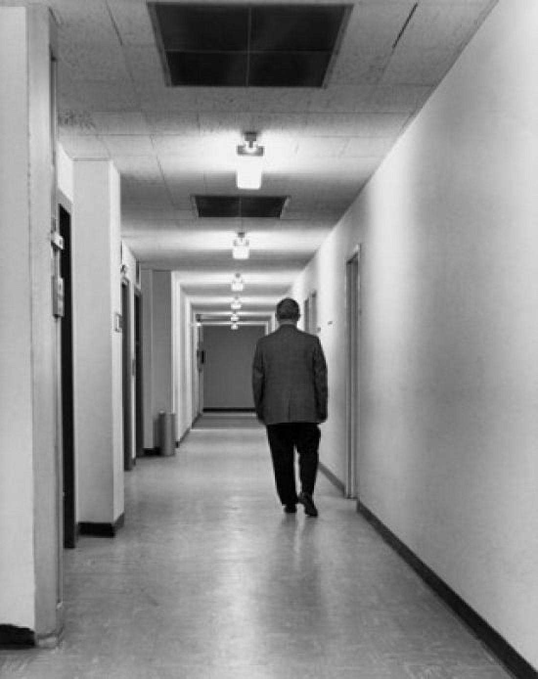 Rear view of businessman walking in corridor Canvas Art - (24 x 36)