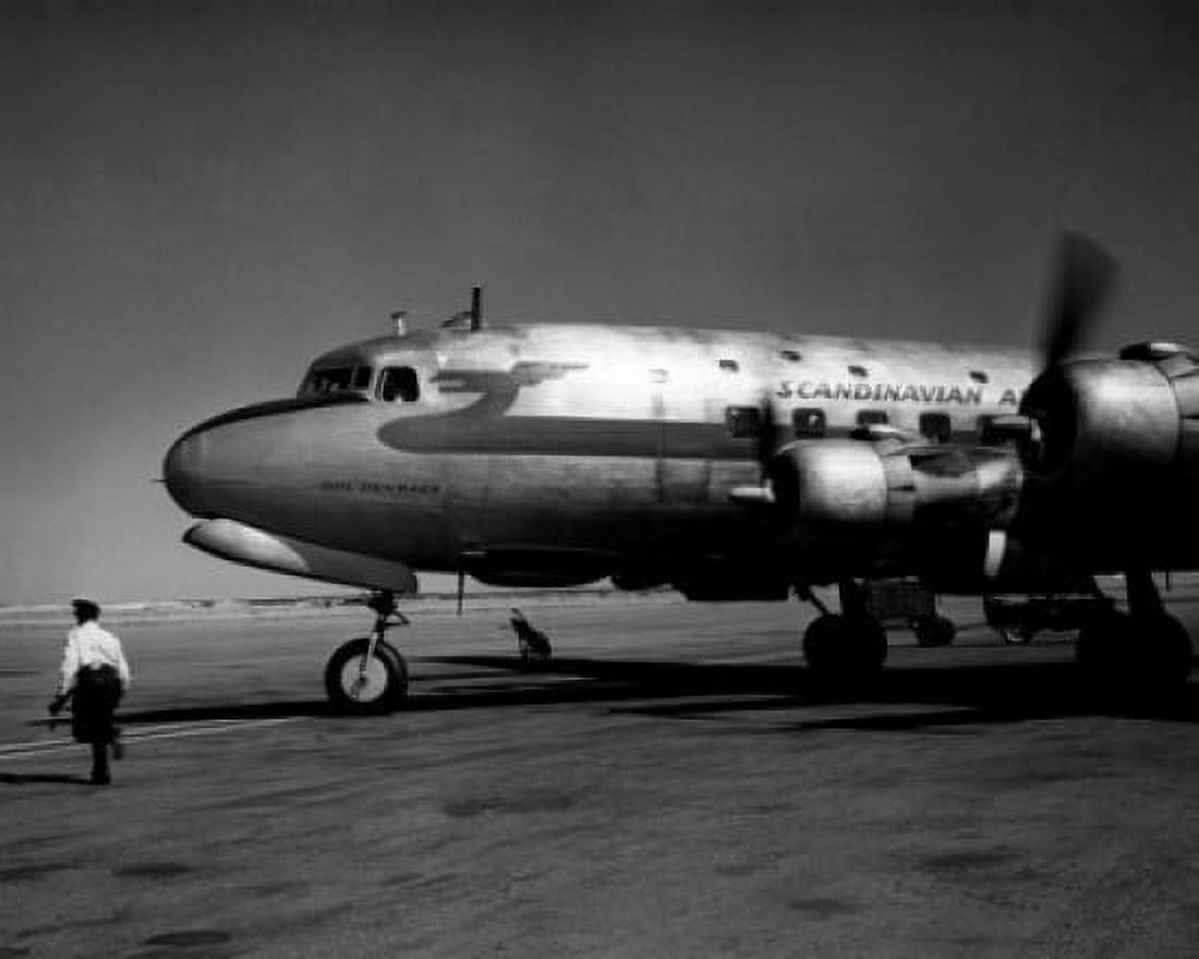 Rear view of man running near airplane Canvas Art - (24 x 36)