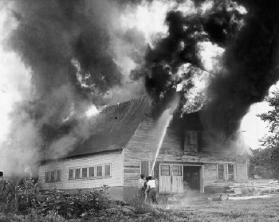 Rear view of three men spraying water on a burning building Canvas Art - (18 x 24)