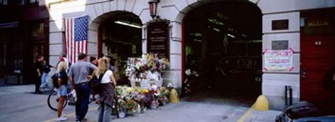 Rear view of three people standing in front of a memorial at a fire station New York City New York State USA Canvas Art - Panoramic Images (18 x 7)