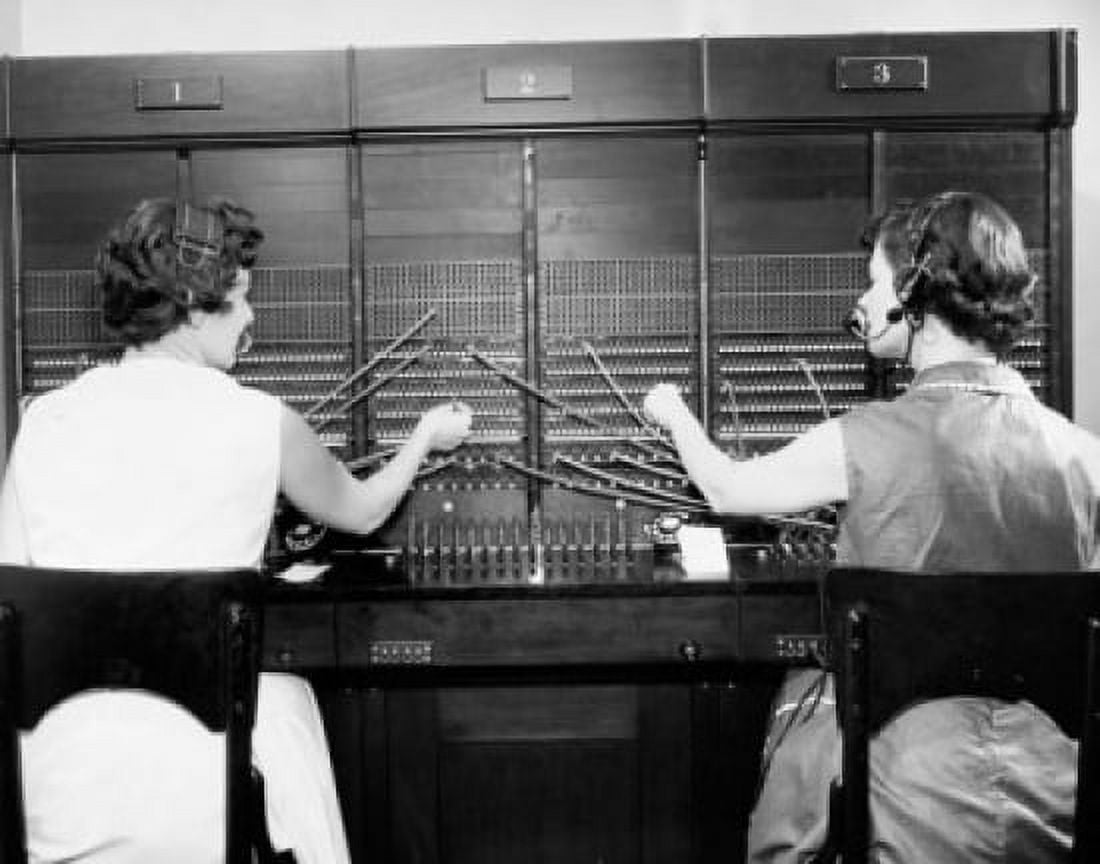 Rear view of two female telephone operators operating a telephone switchboard Canvas Art - (24 x 36)