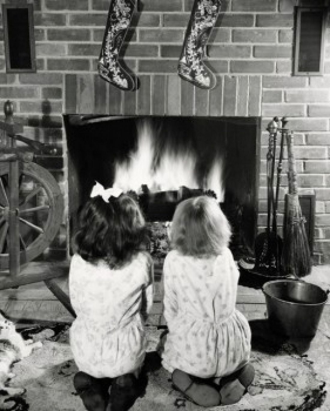 Rear view of two girls kneeling near a fireplace Canvas Art - (18 x 24)