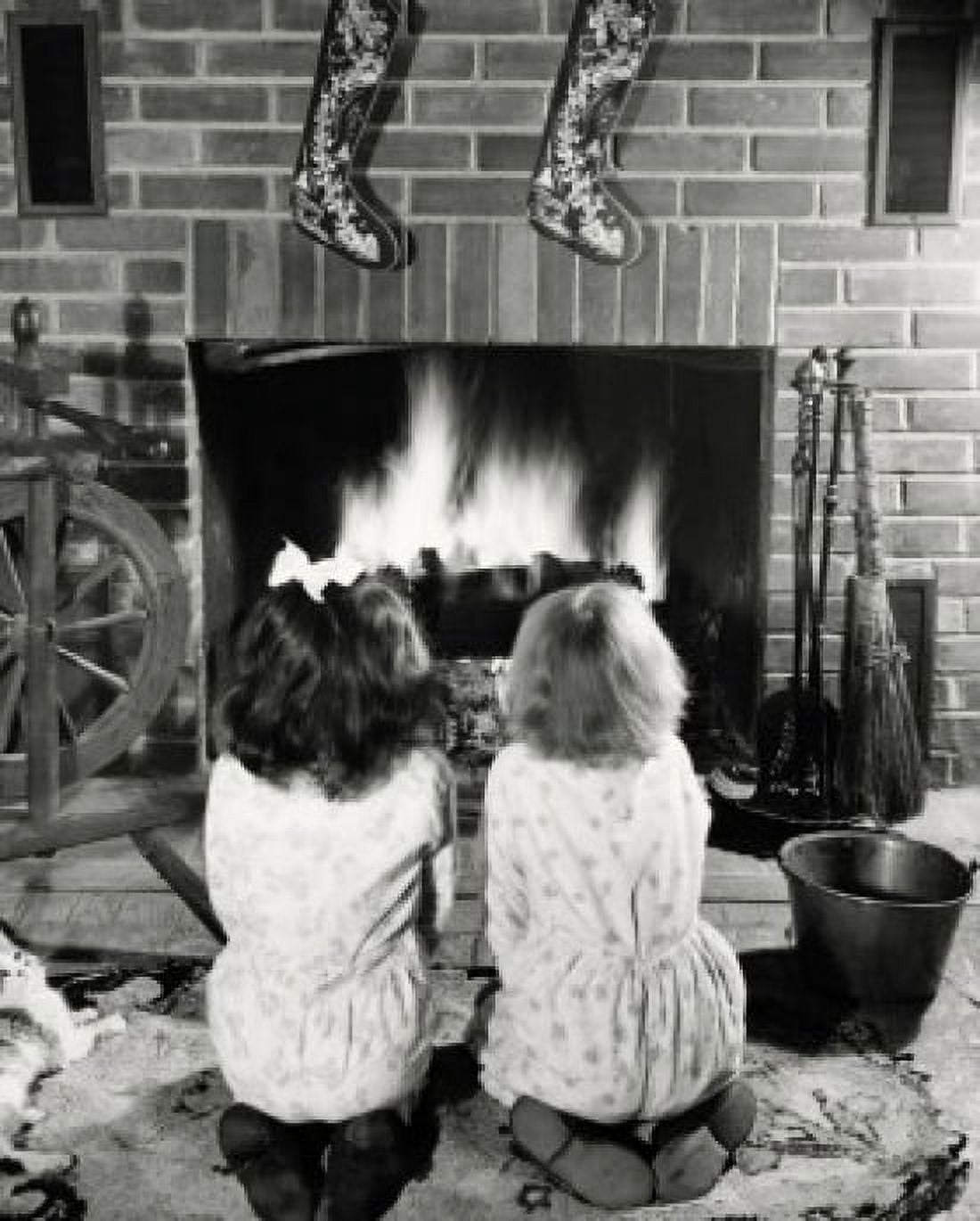 Rear view of two girls kneeling near a fireplace Canvas Art - (24 x 36)