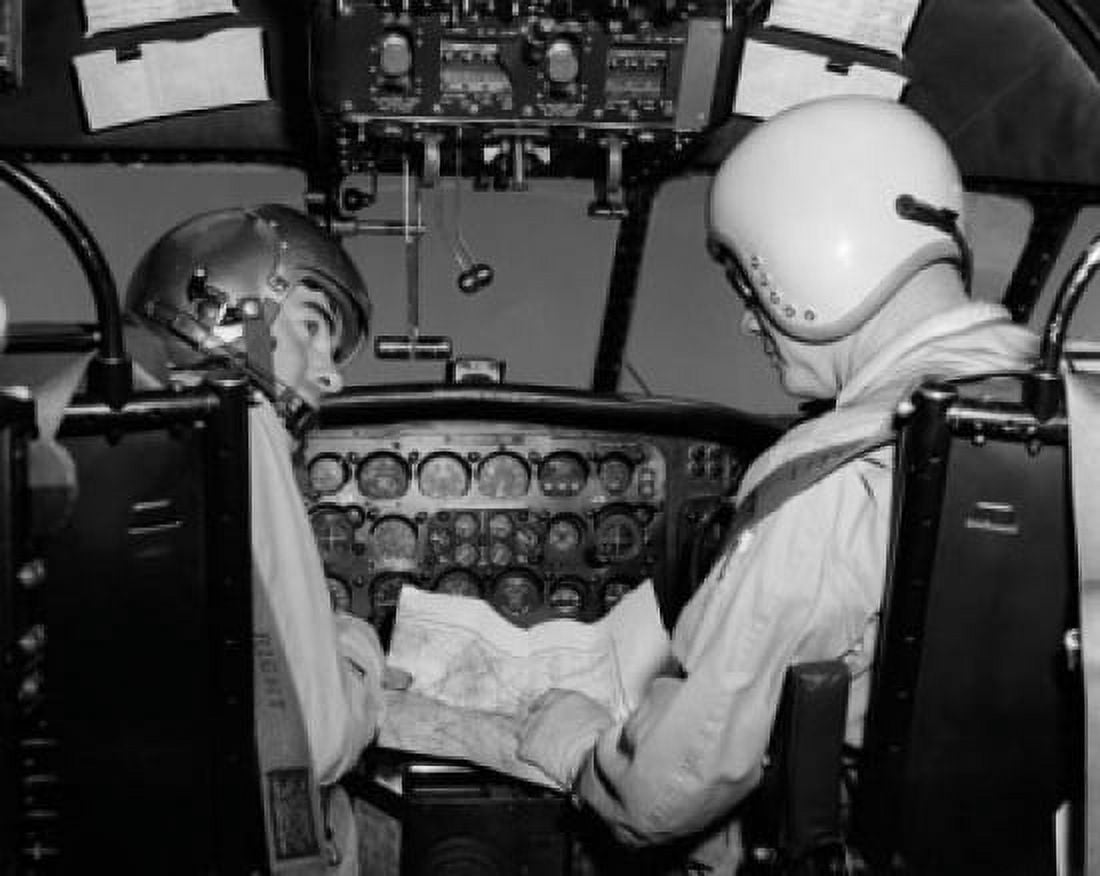 Rear view of two pilots sitting in the cockpit of an airplane and holding a map Canvas Art - (18 x 24)