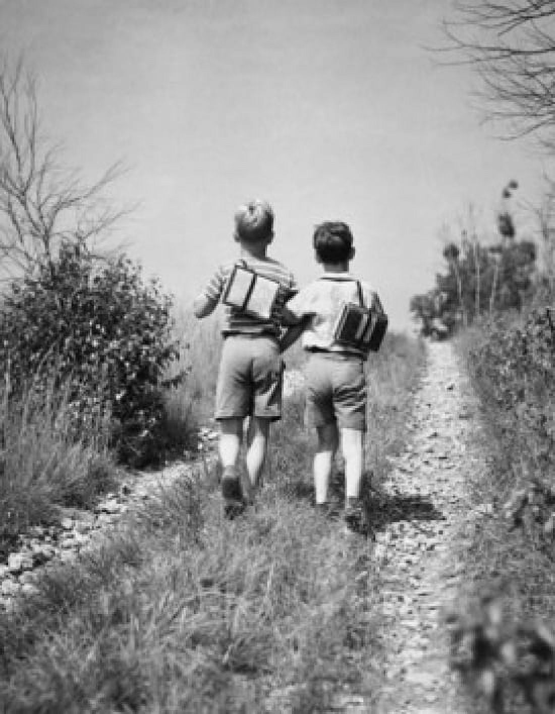 Rear view of two schoolboys walking together along field path Canvas Art - (24 x 36)