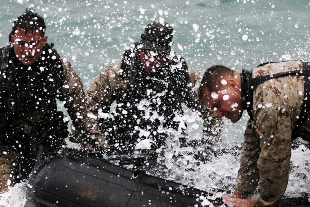 Reconnaissance Marines pull a Zodiac combat rubber reconnaissance craft out of the ocean Canvas Art - Stocktrek Images (34 x 23)