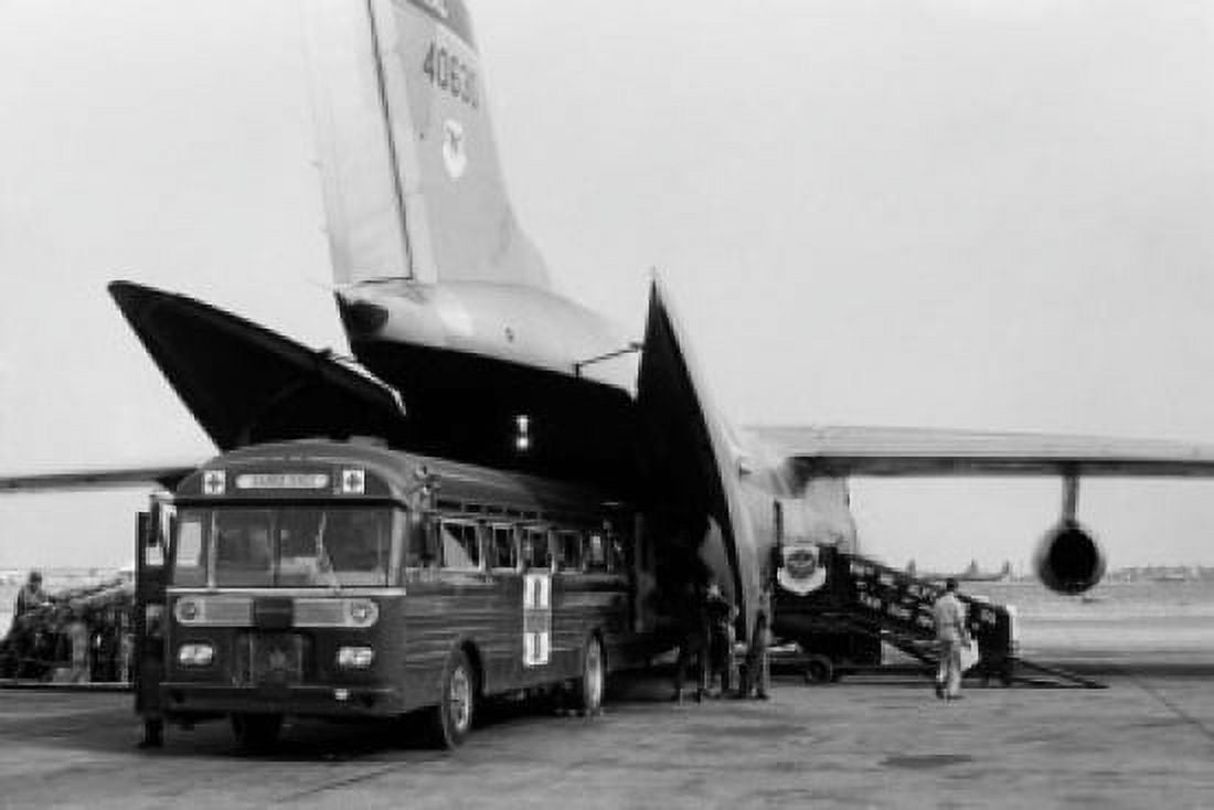 Red Cross bus driving off a military airplane C-141 Starlifter Canvas Art - (18 x 24)