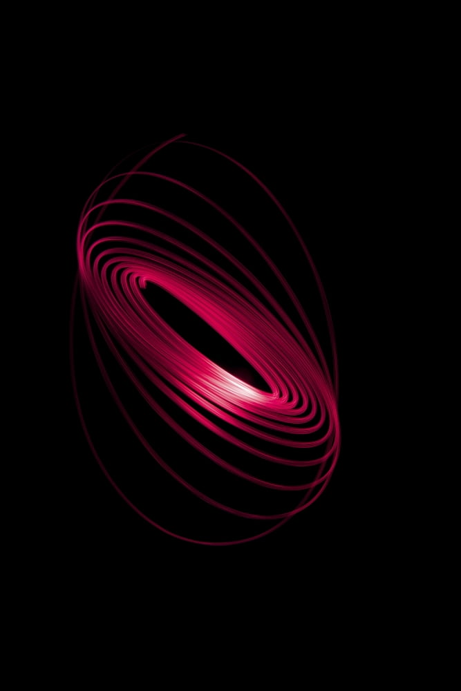 Red light curving in a sphere shape on a black background Canvas Art - Nick Dale Design Pics (12 x 19)