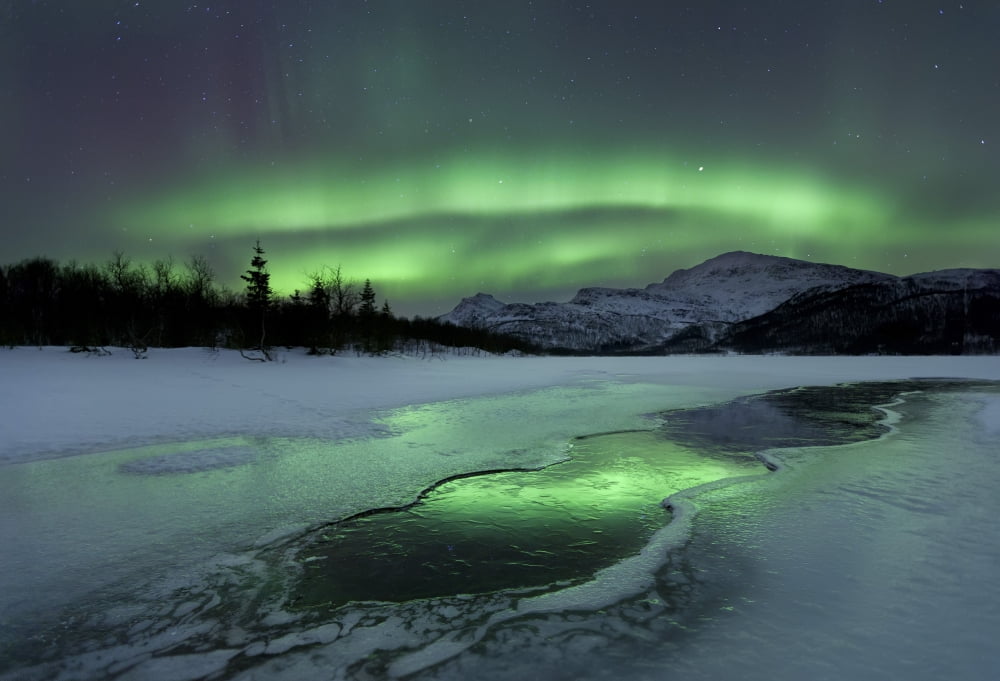 Reflected aurora over a frozen Laksa Lake Nordland Norway Canvas Art - Arild HeitmannStocktrek Images (34 x 23)