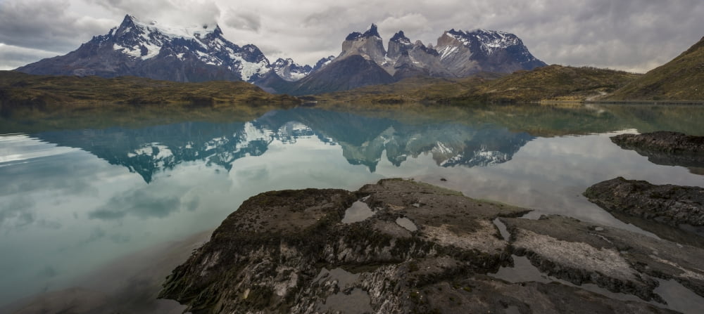Reflection of mountain peaks in a lake Torres Del Paine Cordillera Paine Lake Pehoe Torres Del Paine National Park Chile Canvas Art - Panoramic Images (36 x 12)