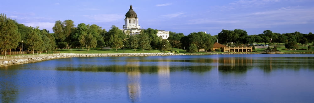 Reflection of a government building in Missouri River South Dakota State Capitol Pierre South Dakota USA Canvas Art - Panoramic Images (12 x 36)