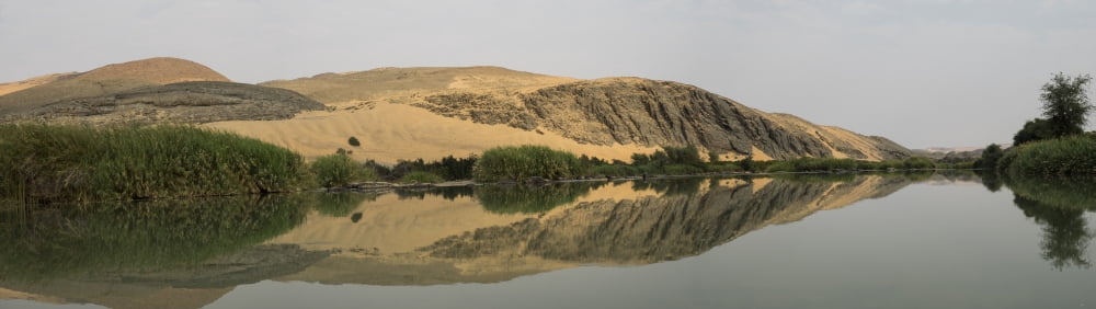 Reflection of a hill on water Hartmann Valley Kunene River Kunene Namibia Canvas Art - Panoramic Images (27 x 9)