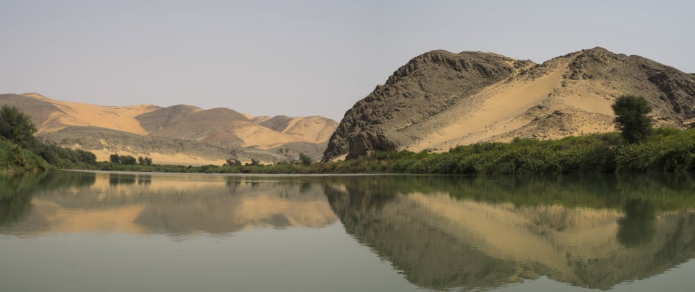 Reflection of a hill on water Hartmann Valley Kunene River Kunene Namibia Canvas Art - Panoramic Images (36 x 12)