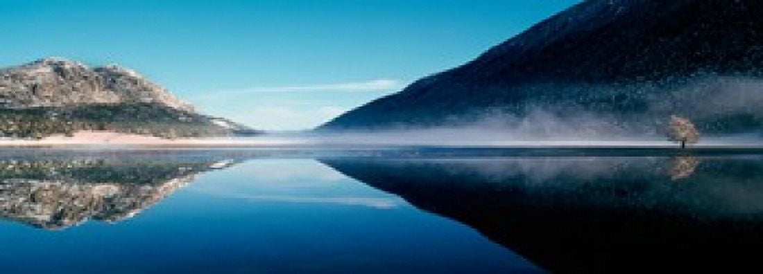 Reflection of a mountain with snowy trees on a lake in winter afternoon Cote dAzur France Canvas Art - Panoramic Images (18 x 7)
