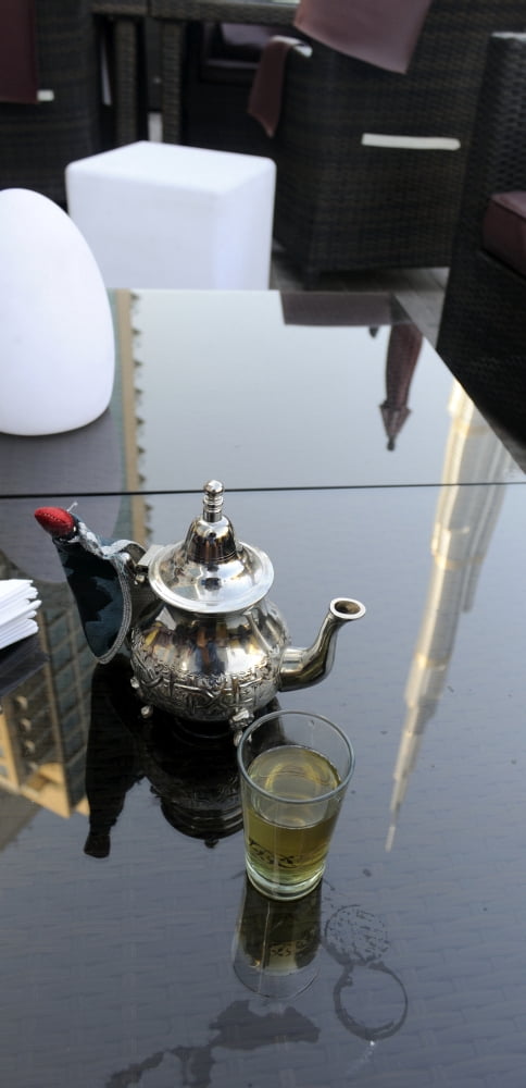 Reflection of a tower on a table in a restaurant on Burj Plaza Burj Khalifa Dubai UAE Canvas Art - Panoramic Images (36 x 12)