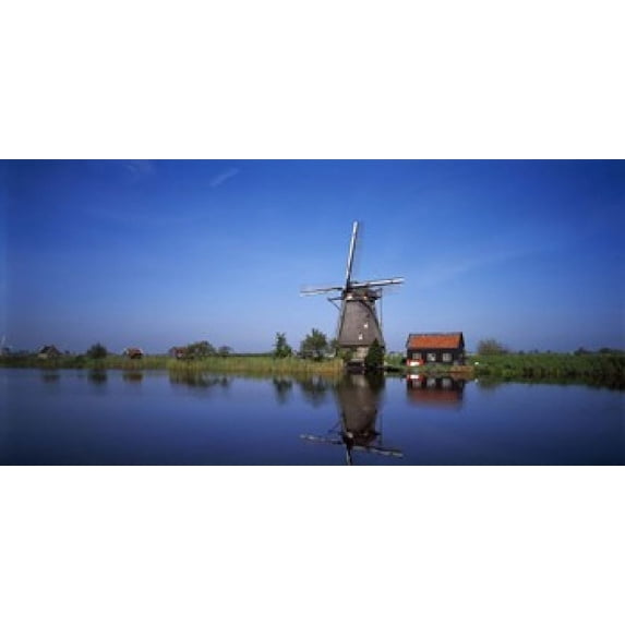 Reflection of a traditional windmill in a lake, Netherlands Poster Print (12 x 6)