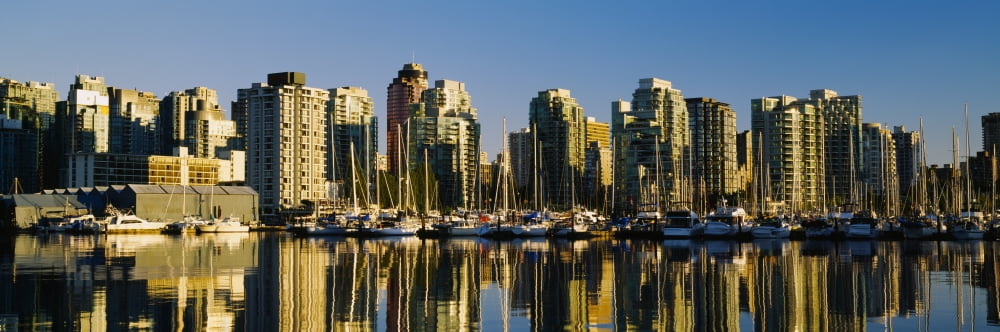 Reflection of buildings in water False Creek Granville Island Vancouver British Columbia Canada Canvas Art - Panoramic Images (27 x 9)