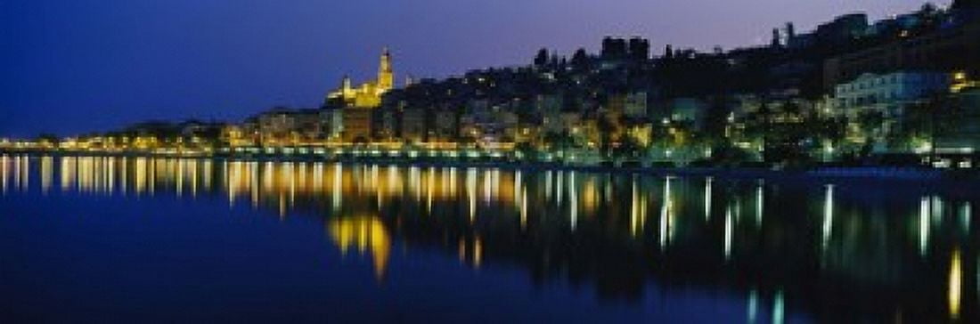 Reflection of buildings in water Menton Alpes-Maritimes Provence-Alpes-Cote dAzur France Canvas Art - Panoramic Images (18 x 6)