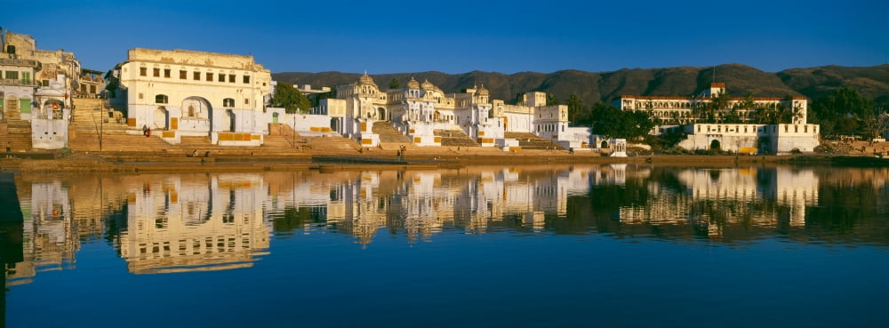 Reflection of buildings on water Lake Pichola Udaipur Rajasthan India Canvas Art - Panoramic Images (27 x 9)
