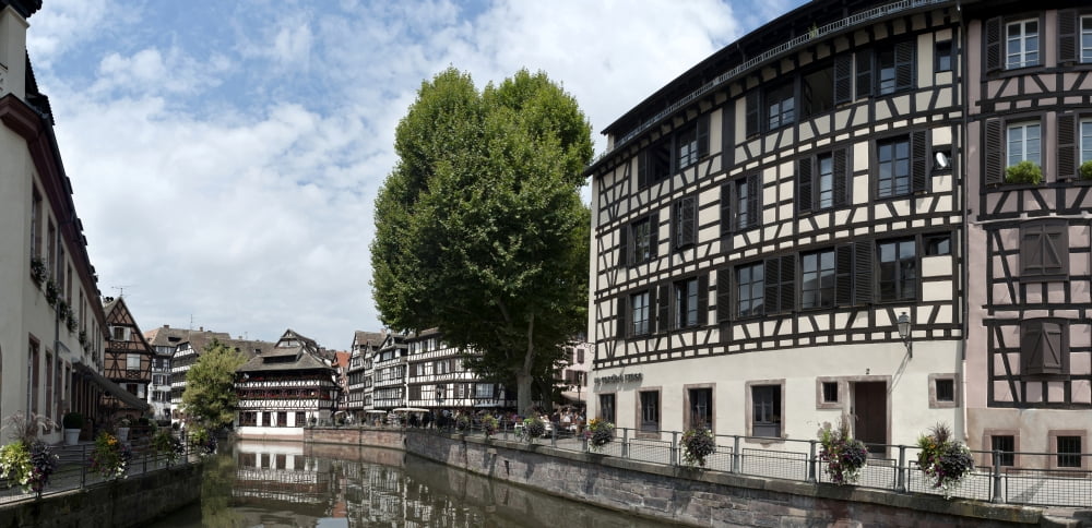 Reflection of buildings on water Petite France Strasbourg Bas-Rhin Alsace France Canvas Art - Panoramic Images (27 x 9)