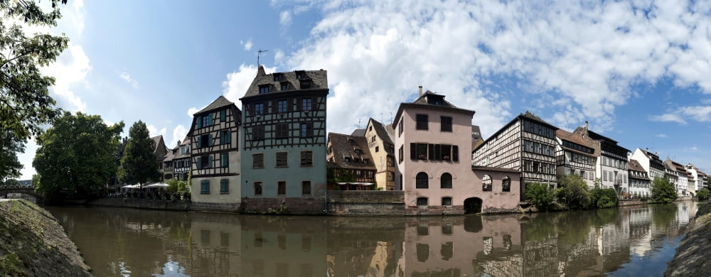 Reflection of buildings on water Petite France Strasbourg Bas-Rhin Alsace France Canvas Art - Panoramic Images (27 x 9)