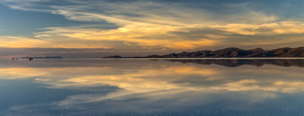 Reflection of clouds in a lake at sunset Salar de Uyuni Altiplano Bolivia Canvas Art - Panoramic Images (27 x 9)