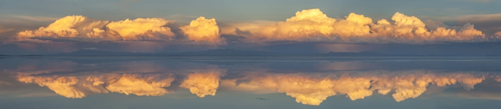 Reflection of clouds in a lake at sunset Salar de Uyuni Uyuni Bolivia Canvas Art - Panoramic Images (27 x 9)