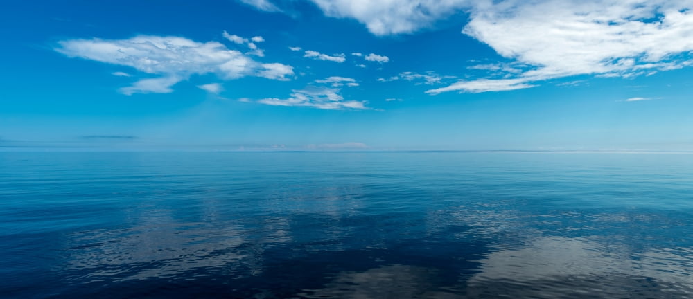 Reflection of clouds on water Lake Superior Minnesota USA Canvas Art - Panoramic Images (13 x 30)