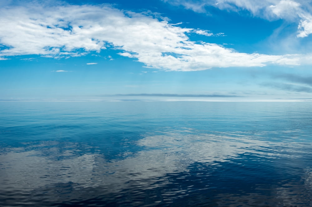 Reflection of clouds on water Lake Superior Minnesota USA Canvas Art - Panoramic Images (18 x 24)