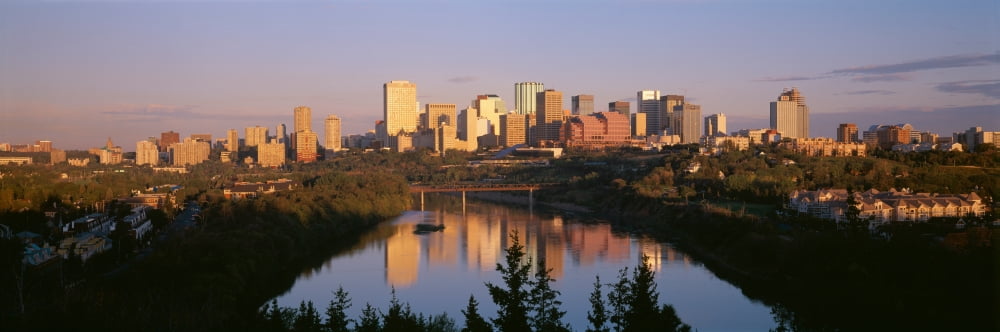 Reflection of downtown buildings in water at sunrise North Saskatchewan River Edmonton Alberta Canada Canvas Art - Panoramic Images (27 x 9)