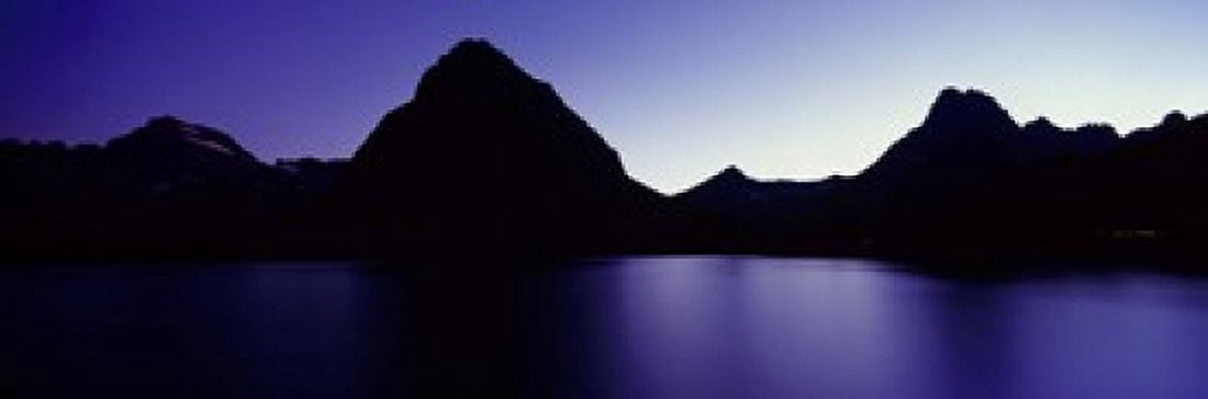 Reflection of mountains in a lake Swiftcurrent Lake Many Glacier US Glacier National Park Montana USA Canvas Art - Panoramic Images (18 x 6)