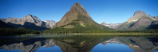 Reflection of mountains in a lake Swiftcurrent Lake Many Glacier US Glacier National Park Montana USA Canvas Art - Panoramic Images (36 x 12)