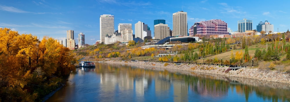 Reflection of skylines in a river North Saskatchewan River Edmonton Alberta Canada Canvas Art - Panoramic Images (7 x 18)