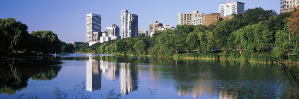 Reflection of skyscrapers on water Milwaukee Wisconsin USA Canvas Art - Panoramic Images (12 x 36)