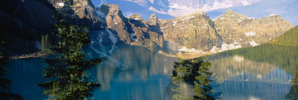 Reflection of trees in water Moraine Lake Banff National Park Alberta Canada Canvas Art - Panoramic Images (6 x 18)