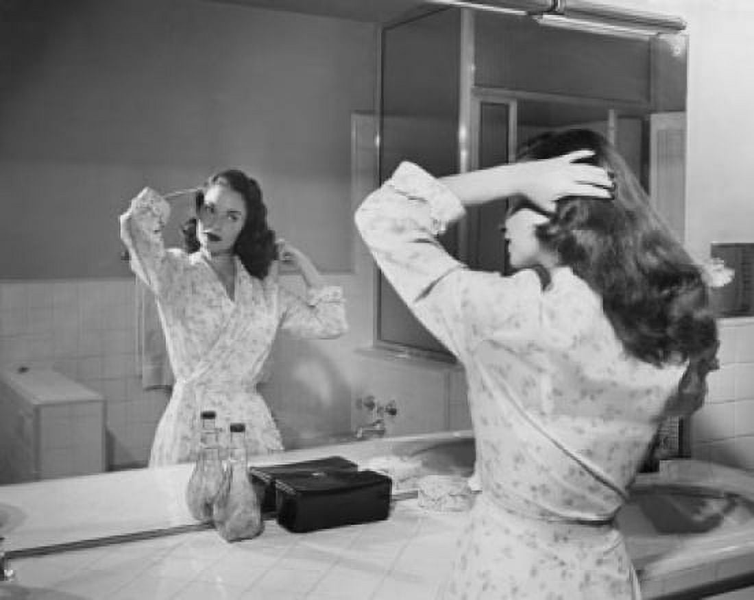 Reflection of young woman brushing her hair in mirror Canvas Art - (18 x 24)