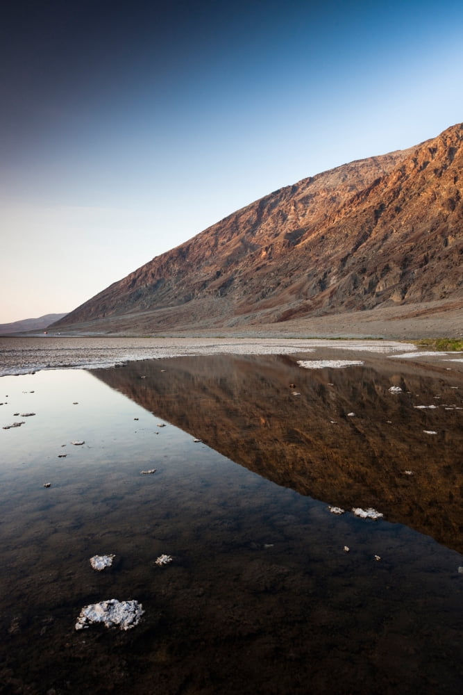 Reflection of rock on water Western Hemisphere Badwater Basin Death Valley National Park Inyo County California USA Canvas Art - Panoramic Images (27 x 9)