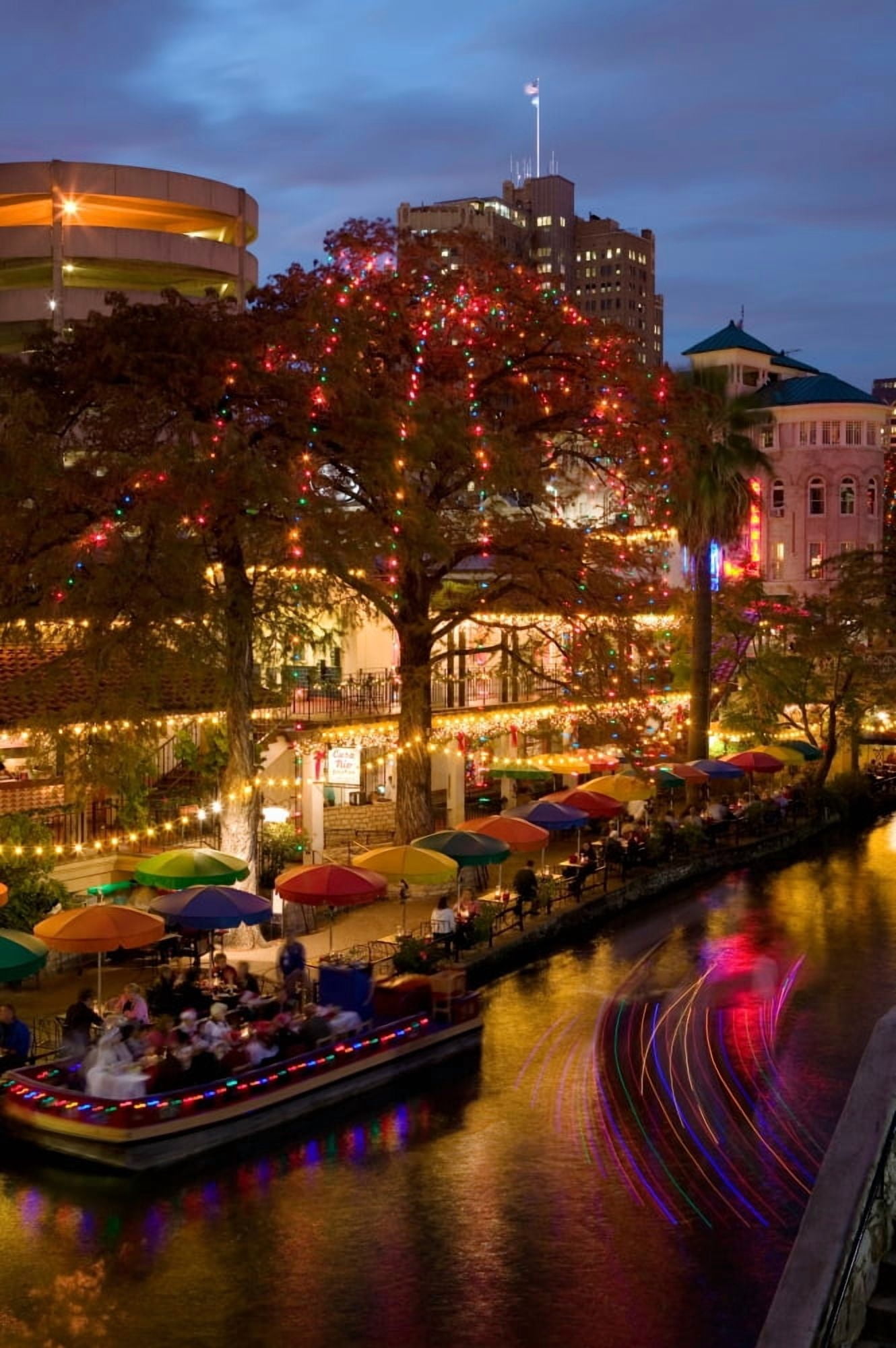 Restaurant along a river lit up at dusk San Antonio River San Antonio Texas USA Canvas Art - Panoramic Images (36 x 12)