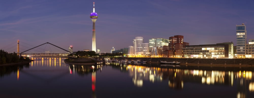 Rheinturm Tower and Gehry buildings at dusk Media Harbour Dusseldorf North Rhine Westphalia Germany Canvas Art - Panoramic Images (24 x 9)