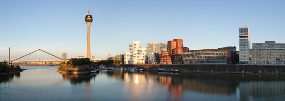 Rheinturm Tower with Neuer Zollhof buildings at Media Harbour Dusseldorf North Rhine Westphalia Germany Canvas Art - Panoramic Images (27 x 9)