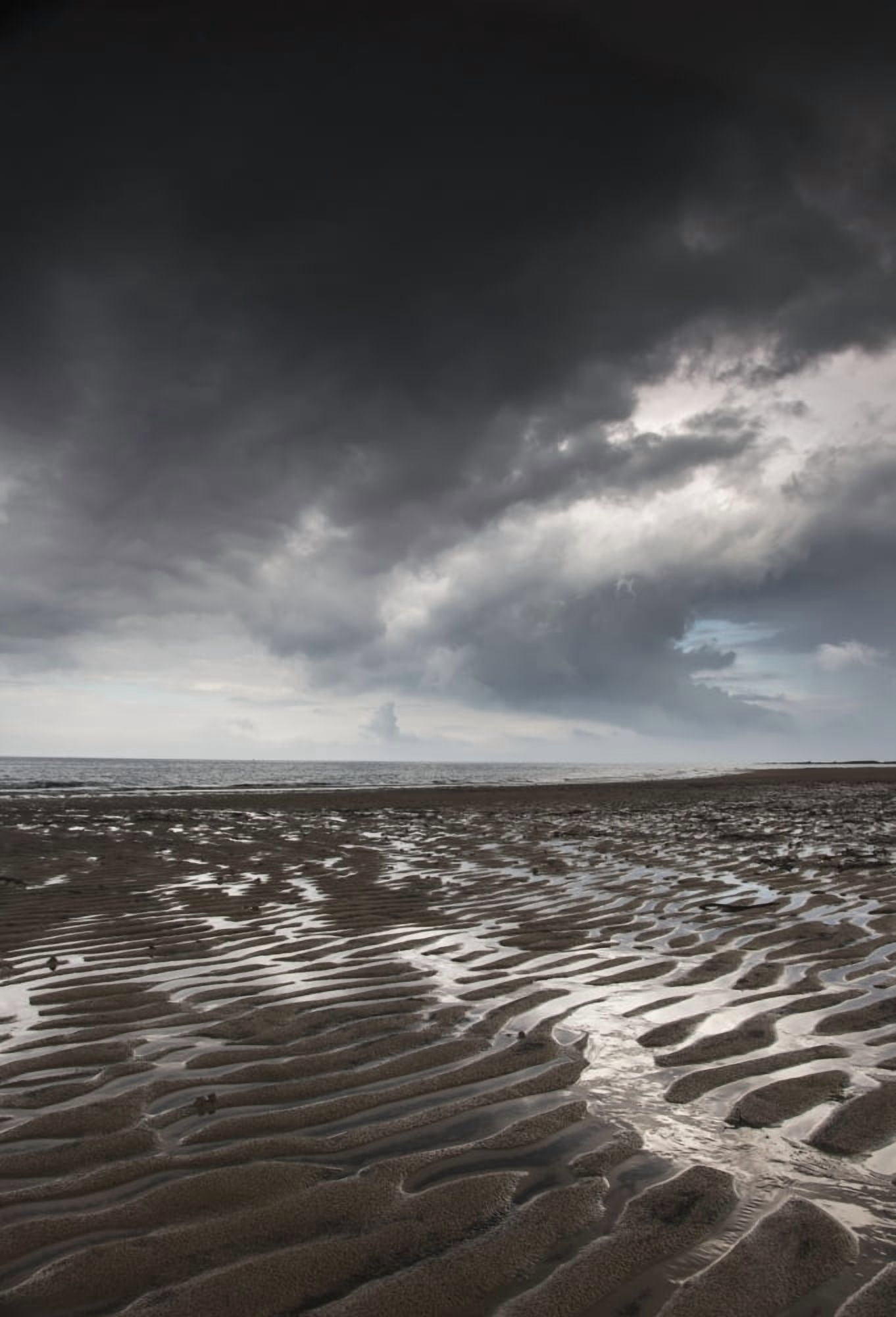 Rippled sand under a dark cloud at the waters edgeNorthumberland england Canvas Art - John Short Design Pics (12 x 18)