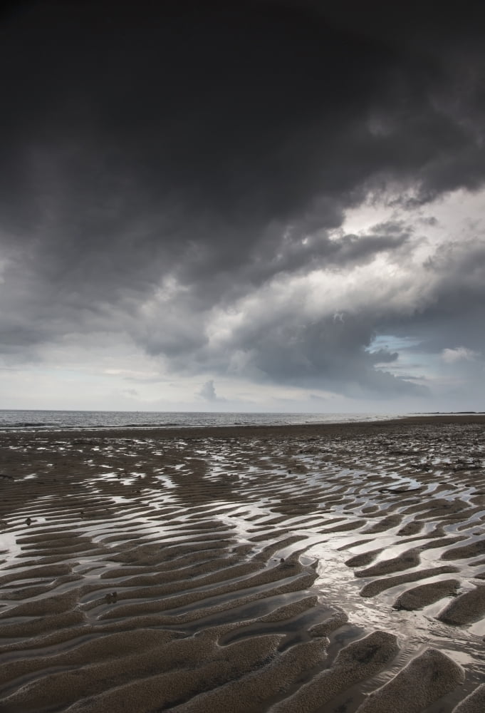 Rippled sand under a dark cloud at the waters edgeNorthumberland england Canvas Art - John Short Design Pics (24 x 36)