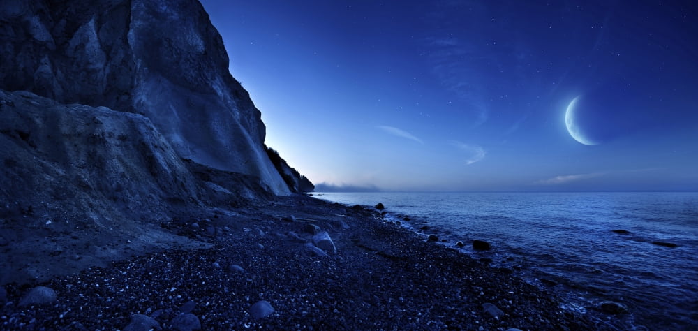 Rising moon over ocean and mountains against starry sky Canvas Art - Evgeny KuklevStocktrek Images (21 x 10)