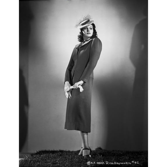 Rita Hayworth standing in Dress and Hat Photo Print (8 x 10)