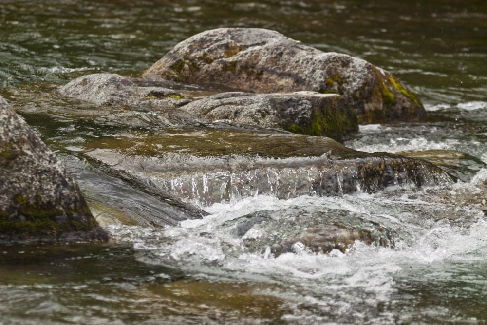 River Water Flowing Downstream Around Rocks Canvas Art - Jeff Schultz Design Pics (17 x 11)