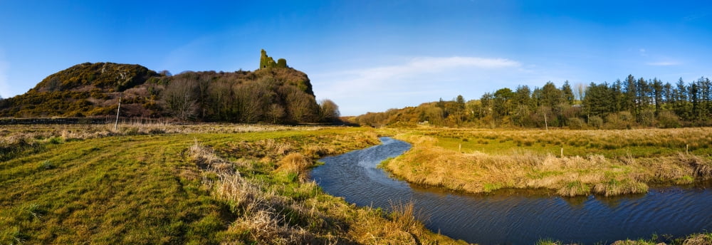 River flowing through landscape with the Dunhill Castle in the background Dunhill County Waterford Republic of Ireland Canvas Art - Panoramic Images (36 x 12)