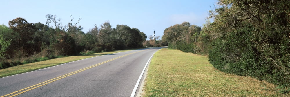 Road leading towards a lighthouse Cape Hatteras Lighthouse Outer Banks North Carolina USA Canvas Art - Panoramic Images (36 x 12)