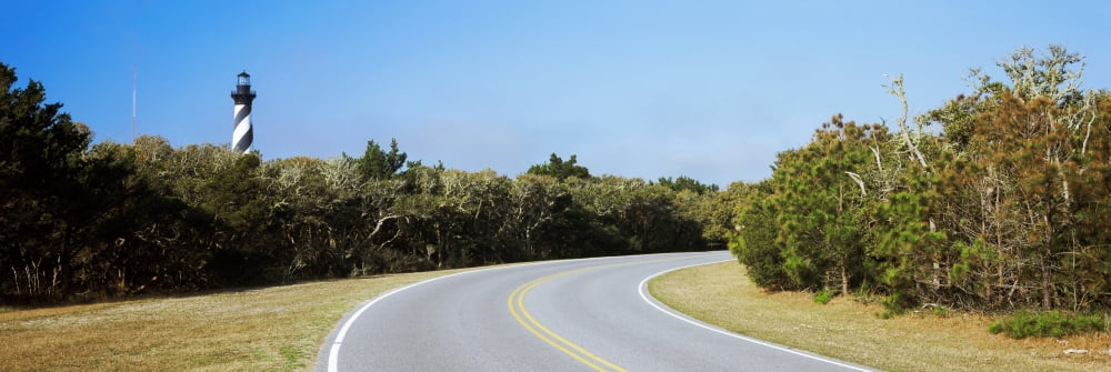 Road leading towards a lighthouse Cape Hatteras Lighthouse Outer Banks North Carolina USA Canvas Art - Panoramic Images (36 x 12)