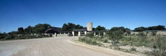 Road leading towards the entrance of a rest camp Okaukuejo Etosha National Park Kunene Region Namibia Canvas Art - Panoramic Images (36 x 13)